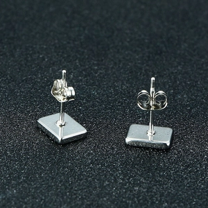 Detailed back view of polished silver rectangle stud earrings with butterfly backs