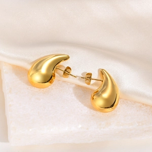 Detailed close-up of gold hollow teardrop earrings with high-polish mirror finish