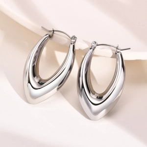 Detailed view of silver hollow water drop hoop earrings with polished metallic finish
