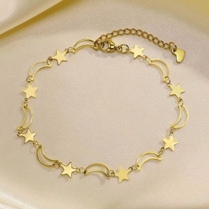 Detail of gold moon and star charms with lobster clasp and heart tag on double layer anklet