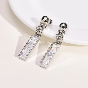 Detail of drop earrings with long copper chain and rectangular cubic zirconia crystals