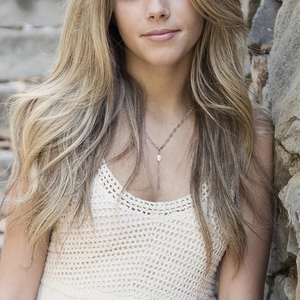 Close-up of Y-shaped stainless steel necklace with freshwater pearl pendant on a model
