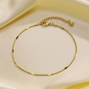 Detail of gold double-layer snake chain anklet with S.Steel engraved heart charm