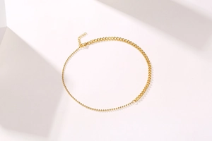 Detail of 18K gold stainless steel mixed bead and link chain with adjustable lobster clasp