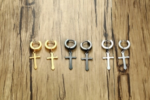 Flat lay of 40mm stainless steel cross hoop earrings in gold, black, and silver finishes