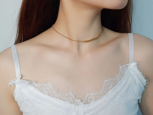 Detail of 18K gold stainless steel asymmetrical choker with bead and link chain