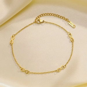 Detail of 18KGP gold-plated double-layer anklet with infinity symbols on silk fabric