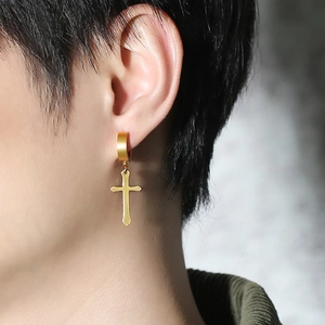 Detail of 40mm golden stainless steel cross earring on model showing polished texture