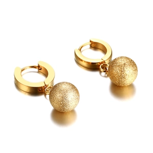 Golden stainless steel hoop earrings with frosted textured sphere charms on white background