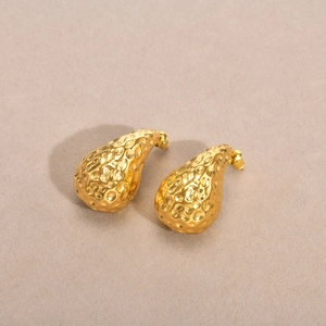 Golden stainless steel teardrop earrings with hammered texture and modern minimalist style