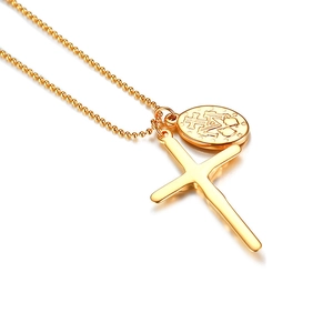 Detail of gold stainless steel ball chain necklace with cross and oval religious pendant