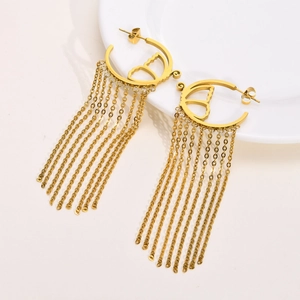 Detailed macro view of golden butterfly tassel earrings with fine dangling chain fringe
