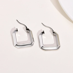 Macro shot of silver geometric square earrings with a high-polished mirror finish