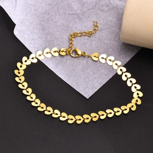 Macro detail of golden heart-shaped link chain with lobster clasp and extension