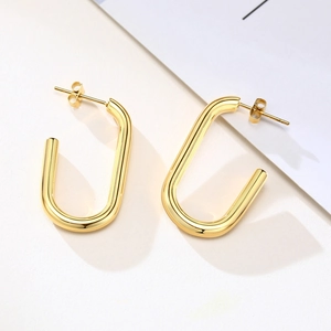 Detailed view of polished gold U-shape geometric earrings with secure butterfly backs