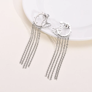 Macro shot of silver butterfly hoop earrings with long stainless steel chain tassels