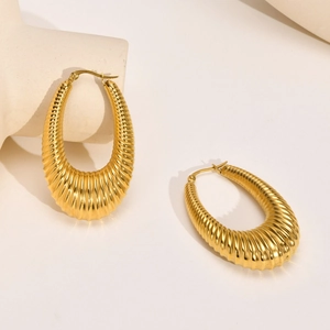 Elegant gold ribbed hollow hoop earrings with textured spiral design for women