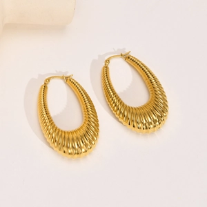 Elegant gold chunky hoop earrings with spiral twist texture and polished mirror finish