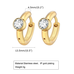 Close-up of 18K gold plated C-shaped earrings with a single white cubic zirconia inlay
