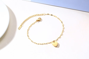 Detail of gold heart pendant chain showing the lobster clasp and K18 metal tag