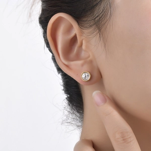 Classic gold bezel set round cubic zirconia stud earrings for women on earlobe