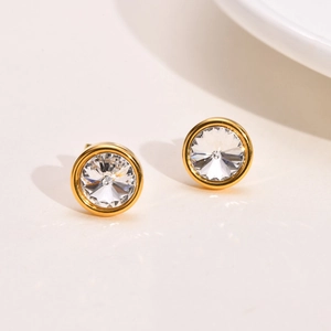 Close-up of gold-plated stainless steel stud earrings with brilliant round-cut zircon stones