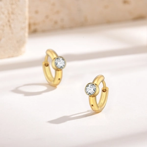 Close-up of 18K gold plated C-shaped hoop earrings with sparkling zircon gemstones