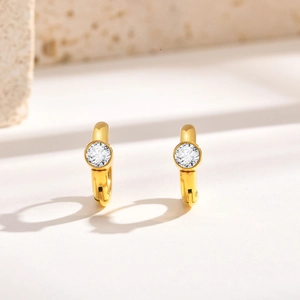 Macro side view of 18K gold plated C-shape hoop earrings with a large round zircon stone