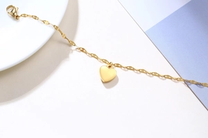 Polished gold heart pendant necklace with flat link chain and lobster clasp detail