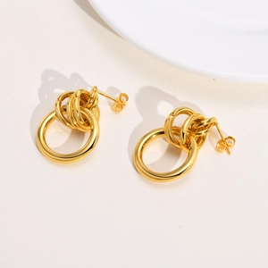 Macro detail of intertwined golden stainless steel rings with a polished mirror finish