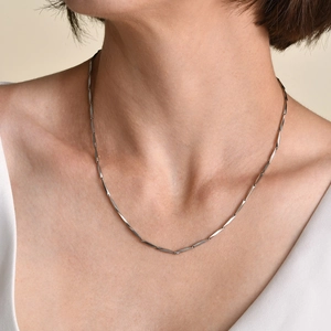 Elegant silver stainless steel twisted link necklace worn on model's collarbone