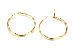 Detailed view of large gold twisted Mobius hoop earrings with polished steel finish