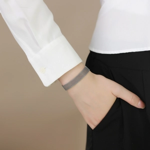 Close-up of a silver mesh strap bracelet featuring flat metal weaving for daily wear