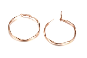 Macro detail of rose gold Möbius twist hoop earrings in polished stainless steel