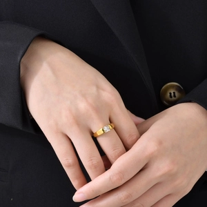 Detailed view of wide 18k gold plated titanium ring featuring a square clear zircon stone