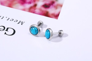 Close-up of turquoise stud earrings with silver stainless steel screw-back closure