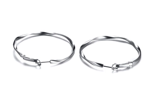 Detail shot of silver mobius twisted hoop earrings with a polished spiral texture