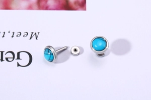 Detail of round silver turquoise earrings showing the side structure and gemstone texture