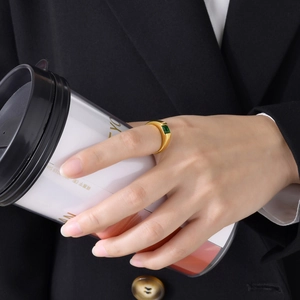 Chic 18k gold titanium ring with square green zircon worn by a model holding a white cup