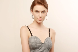 Close-up of minimalist large silver hoop earrings paired with a plaid tube top