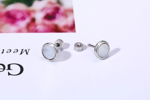 Detailed view of silver stainless steel stud earrings with white mother of pearl inlay