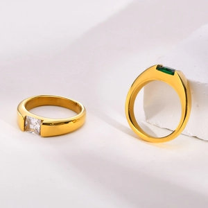 Close-up of minimalist gold titanium rings with square green and white zircon stones