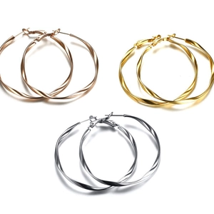 Three pairs of twisted hoop earrings in gold, silver, and rose gold stainless steel set