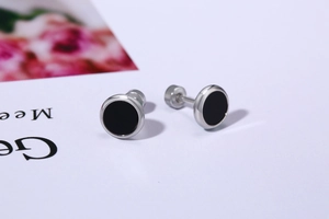 Detail of turquoise stud earrings with silver frame and secure screw back closure