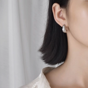 Minimalist silver teardrop stud earrings for women with high-polish metallic finish