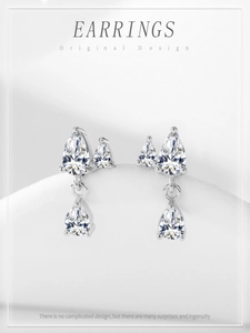 Macro detail of 925 sterling silver pear-shaped tassel earrings with zircon stones