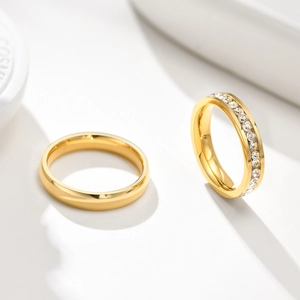 Close-up of gold titanium steel ring set with one plain band and one pavé cubic zirconia band