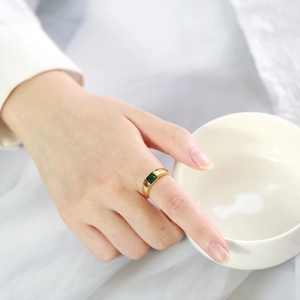 Detailed view of an 18k gold plated ring featuring a square-cut green zircon gemstone