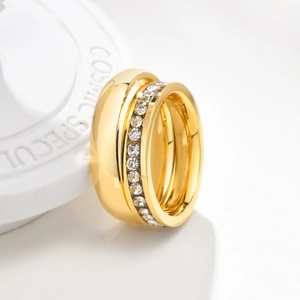 Macro detail of gold-plated titanium ring with inlaid clear cubic zirconia crystals