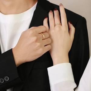 Pair of gold titanium steel couple rings with classic band and cubic zirconia inlay